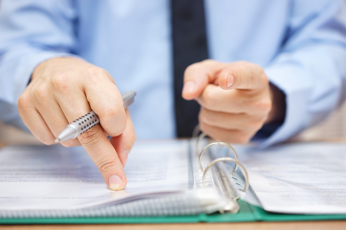 Tax inspector is pointing to you, tax evasion concept